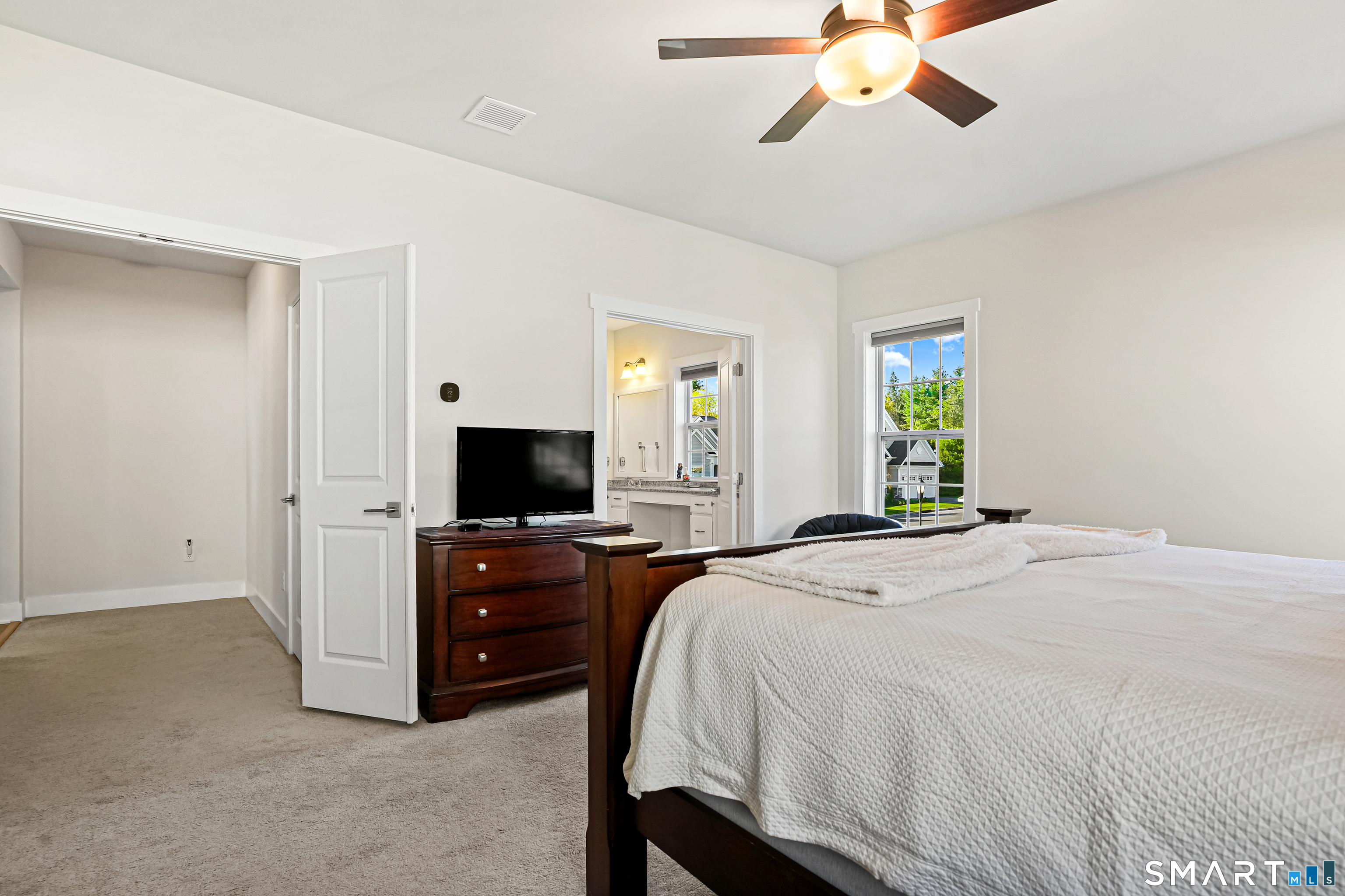 19 Enclave Circle, Unit 19 Newtown, CT 06470 - Photo 29 of 39 a bedroom with a bed and a flat tv screen on dresser
