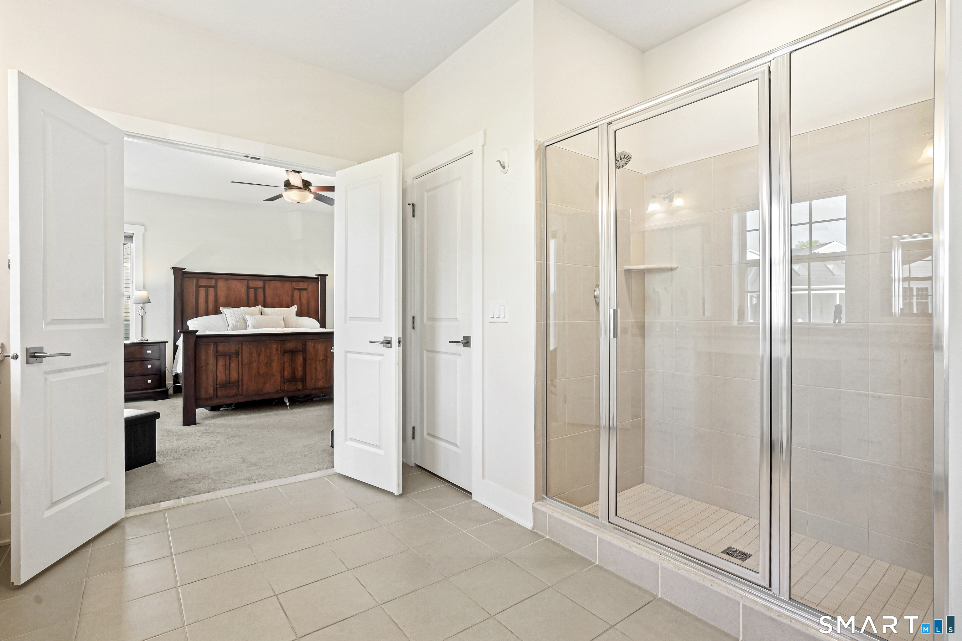 19 Enclave Circle, Unit 19 Newtown, CT 06470 - Photo 7 of 39 a spacious bathroom with a glass shower door and a glass door