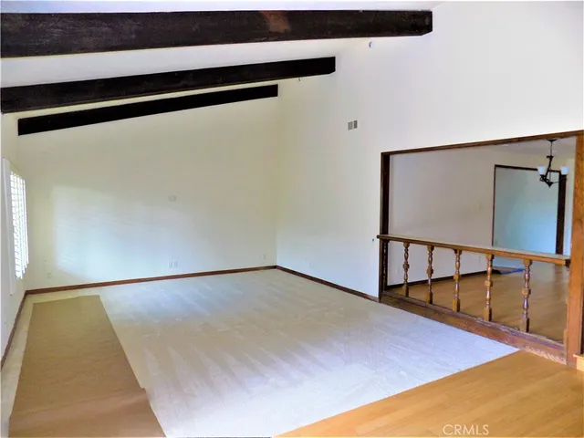 a view of a room with wooden floor