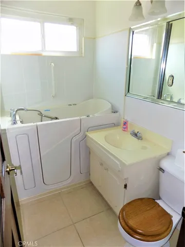 a bathroom with a sink toilet and mirror
