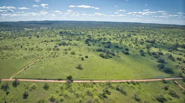 a view of a swimming pool with a yard