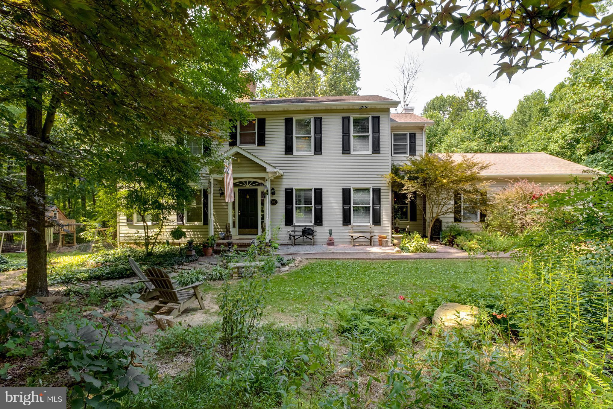 a front view of a house with swimming pool having outdoor seating