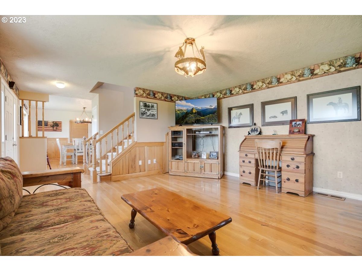 20242 Olmstead Road Northeast Aurora, OR 97002 - Photo 5 of 32 a living room with furniture and wooden floor
