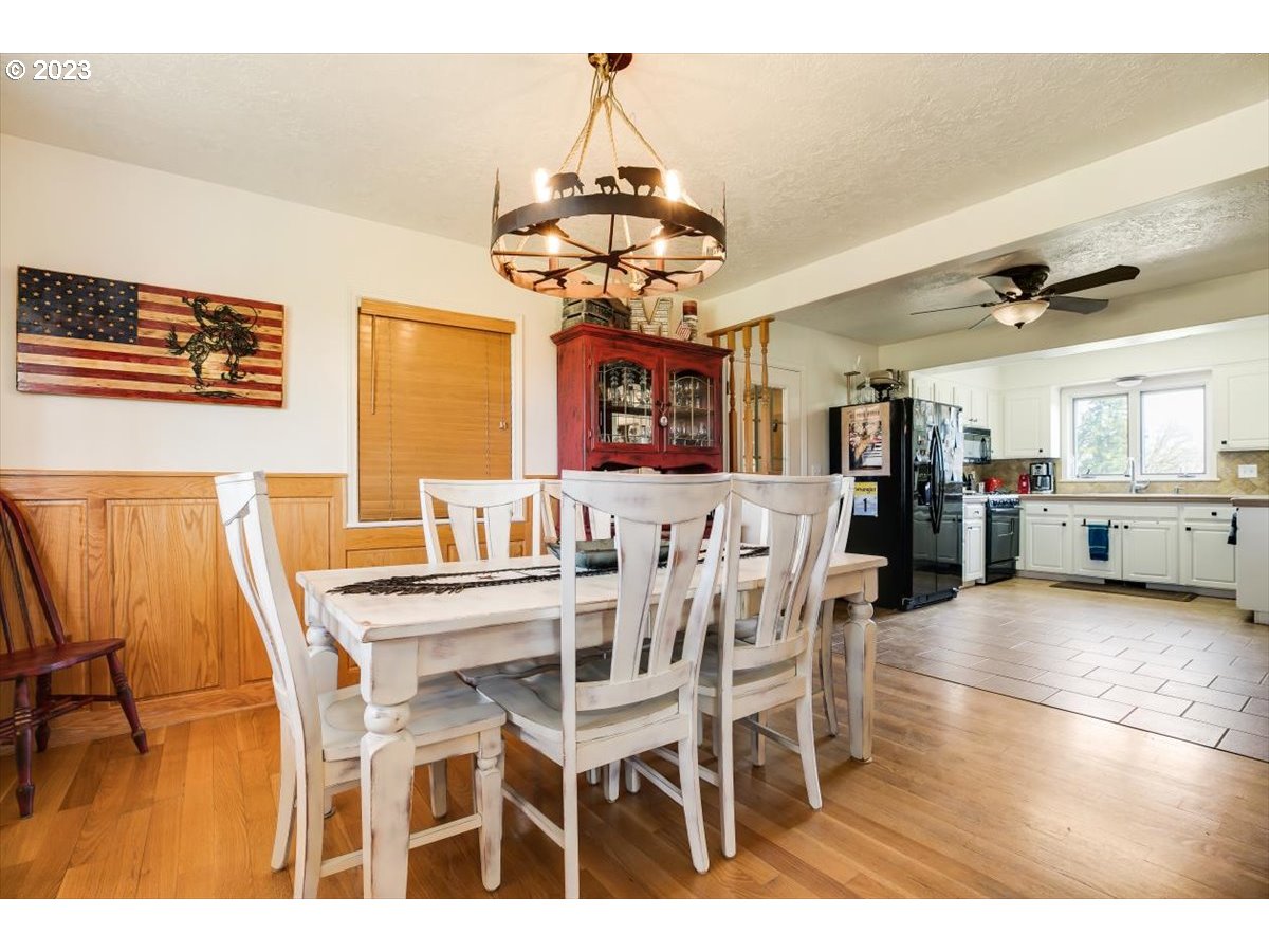 20242 Olmstead Road Northeast Aurora, OR 97002 - Photo 8 of 32 a view of a dining room with furniture and wooden floor