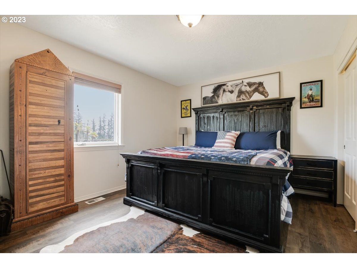 20242 Olmstead Road Northeast Aurora, OR 97002 - Photo 10 of 32 a bed room with a bed and a window