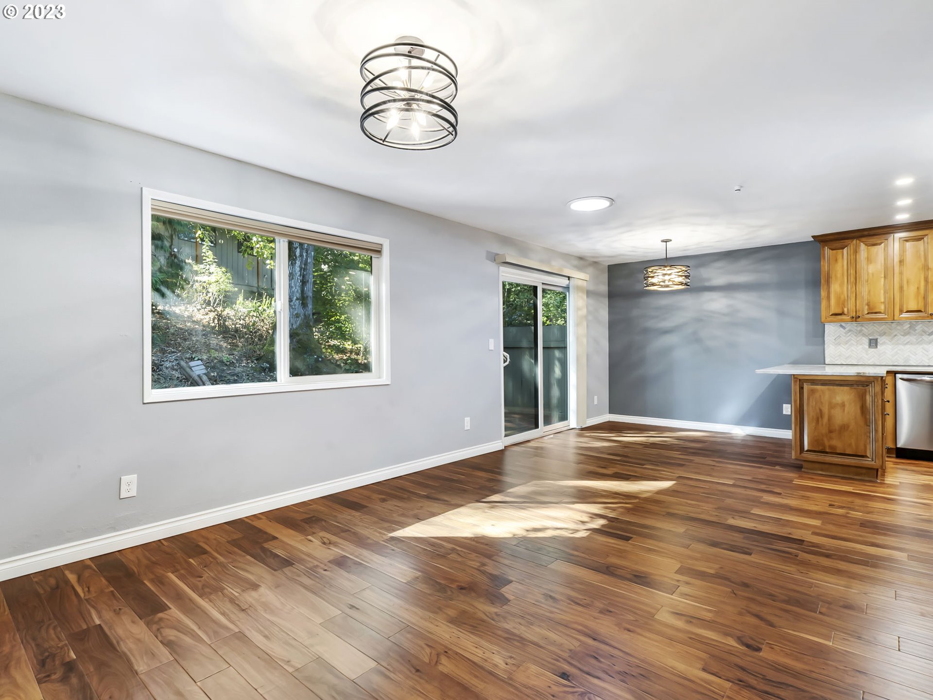 3851 Southwest Canby Street Portland, OR 97219 - Photo 13 of 32 a view of empty room with wooden floor and window