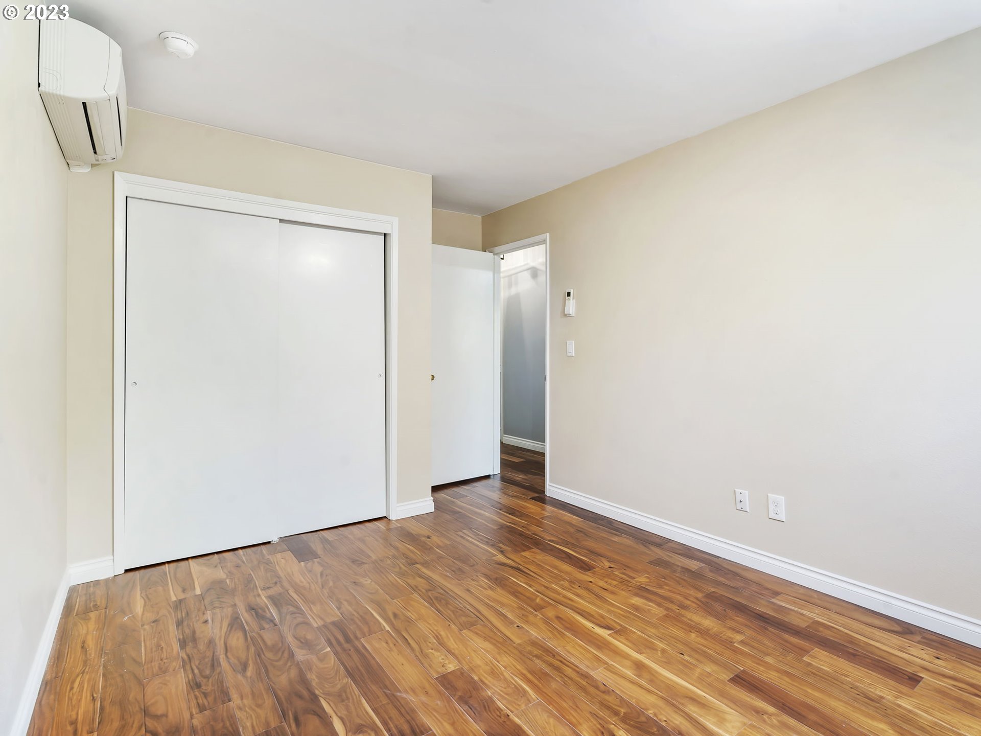 3851 Southwest Canby Street Portland, OR 97219 - Photo 20 of 32 a view of an empty room with wooden floor and a window