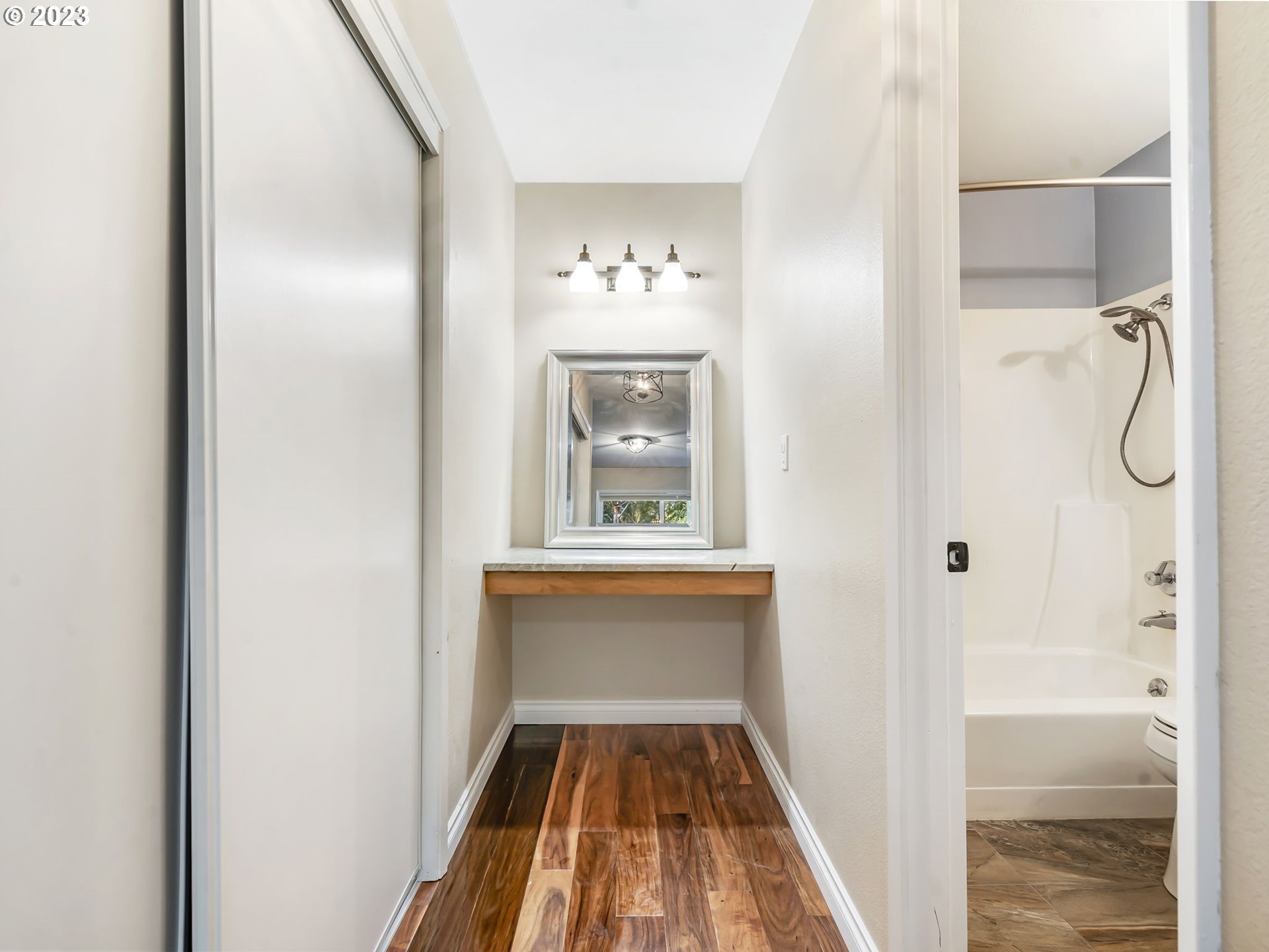 3851 Southwest Canby Street Portland, OR 97219 - Photo 26 of 32 a view of a hallway view with wooden floor and a bathroom