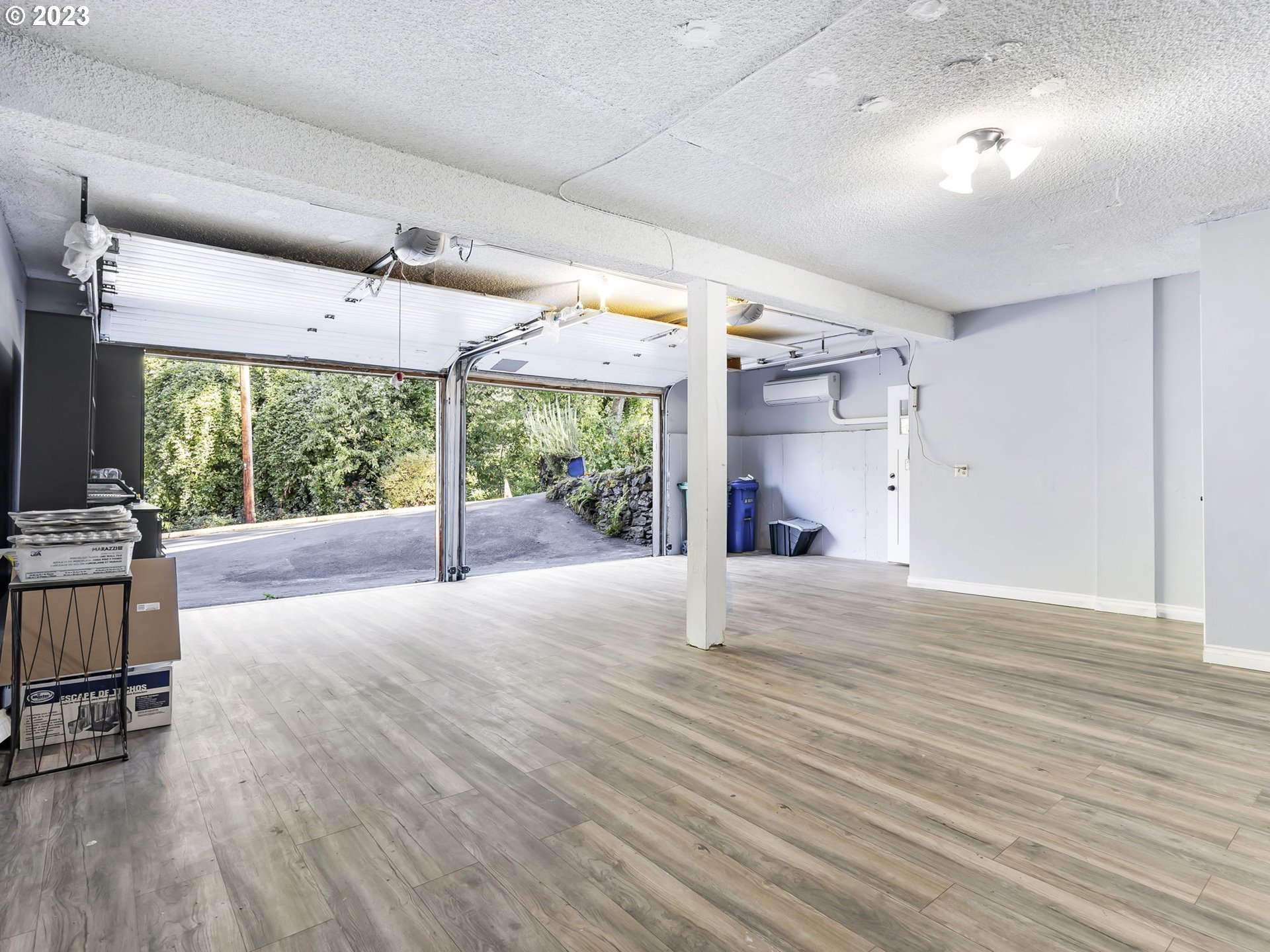3851 Southwest Canby Street Portland, OR 97219 - Photo 32 of 32 an empty room with wooden floor and windows