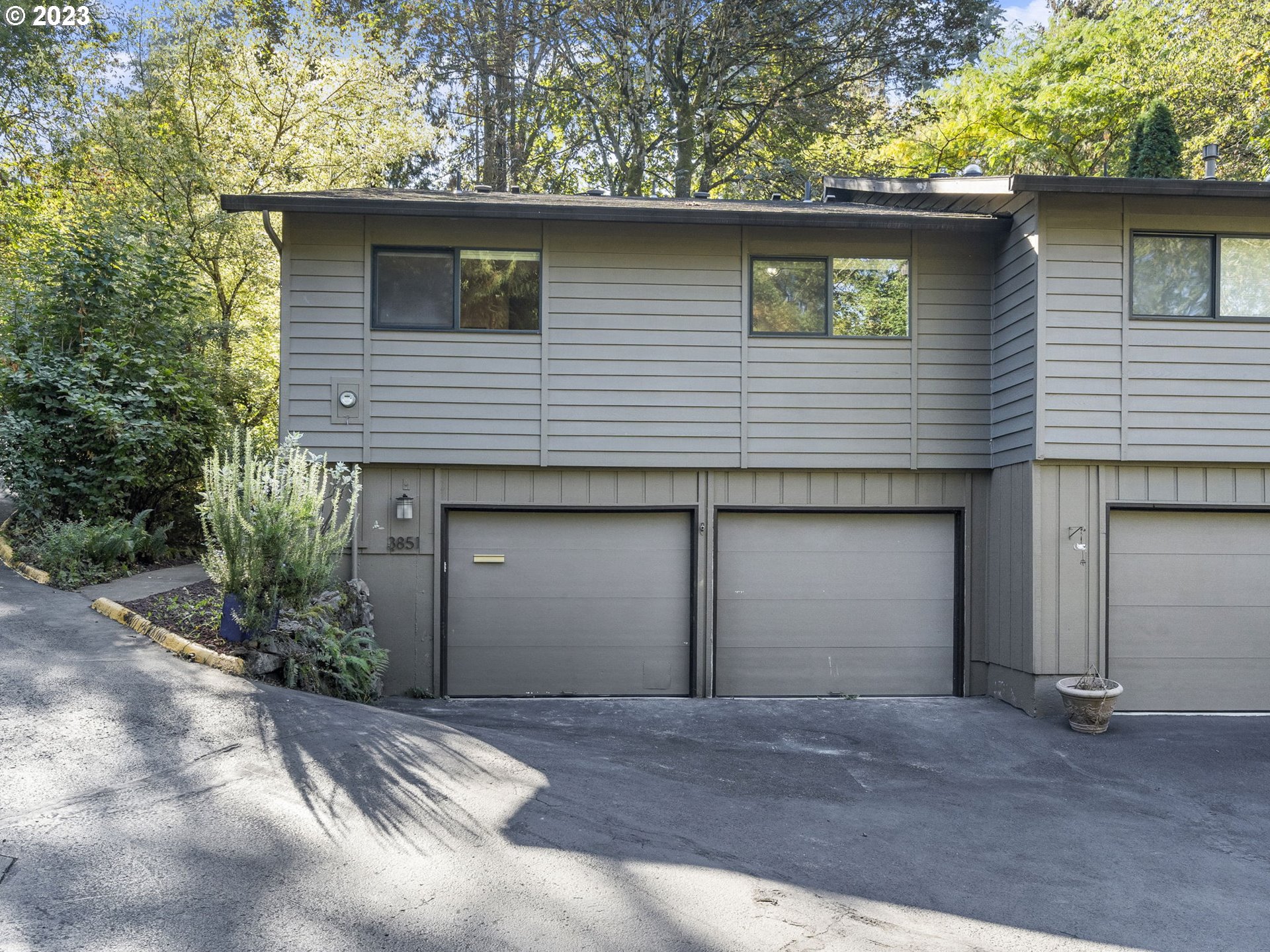 3851 Southwest Canby Street Portland, OR 97219 - Photo 4 of 32 a front view of a house with a garage
