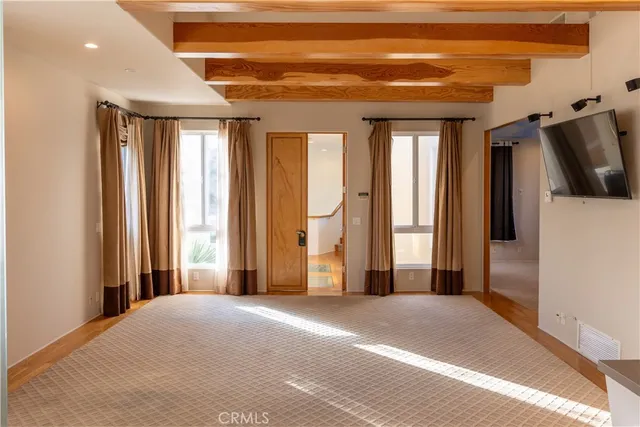 a view of a livingroom with wooden floor and windows