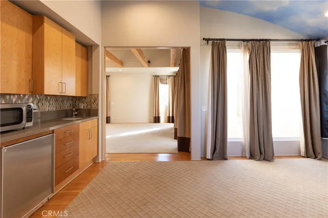 a view of a kitchen with a sink and cabinets
