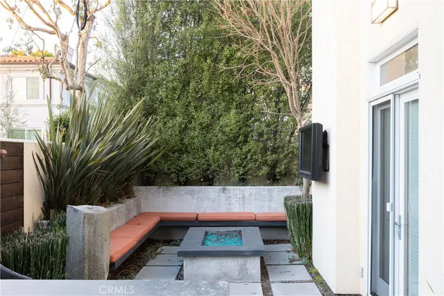 a view of a patio with table and chairs and potted plants