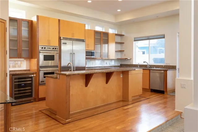 a kitchen with stainless steel appliances granite countertop a stove and a refrigerator