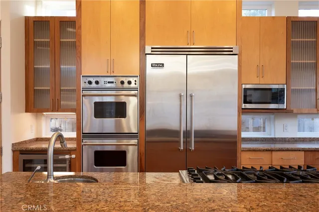 a kitchen with a refrigerator and a stove top oven
