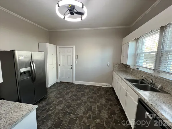 a kitchen with a refrigerator and a sink
