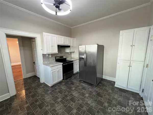 a kitchen with stainless steel appliances a refrigerator a sink a stove a microwave and island
