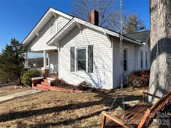a backyard of a house with yard and outdoor seating