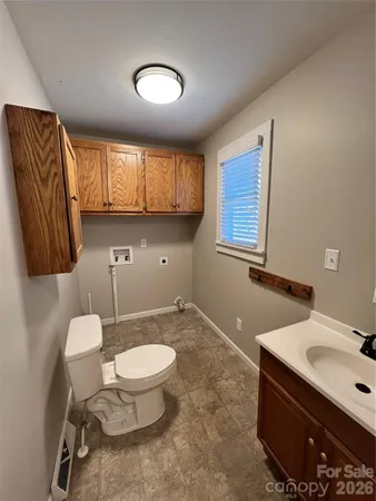 a bathroom with a sink a toilet and mirror