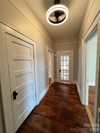 a view of an empty room and wooden floor