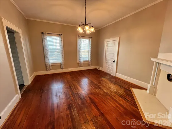 a view of a room with wooden floor and staircase