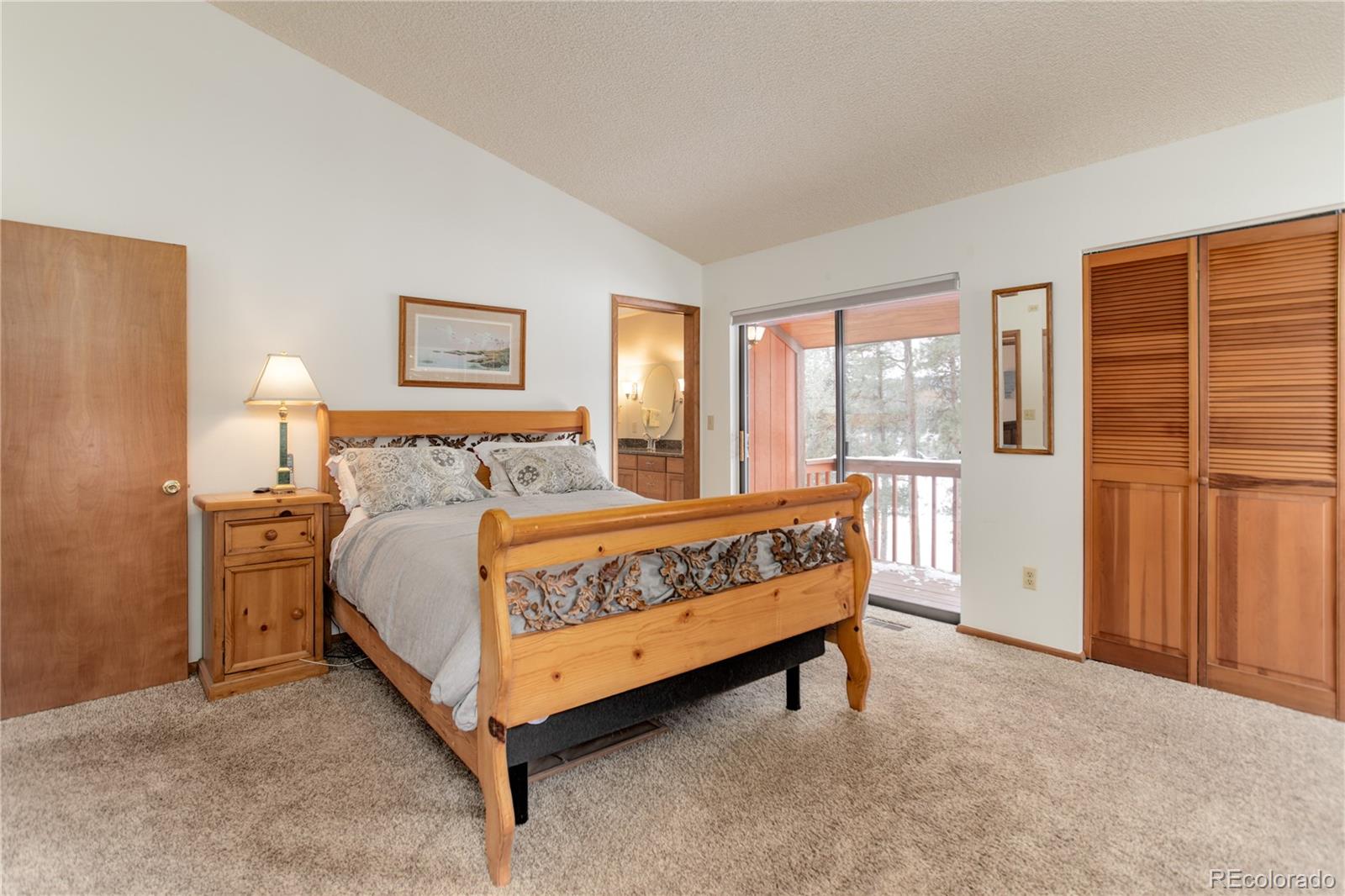 129 Bulldogger Road Bailey, CO 80421 - Photo 18 of 40 a bed sitting in a bedroom next to a window