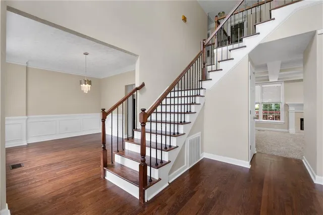 a view of entryway with wooden floor and stairs
