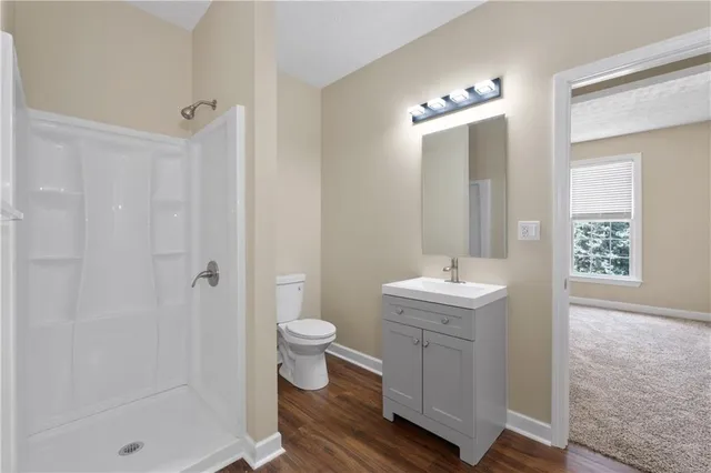 an empty room with windows and fireplace