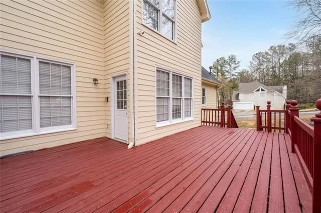 a view of deck with wooden floor and trees