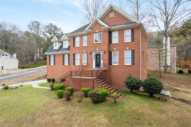 a front view of a house with a yard