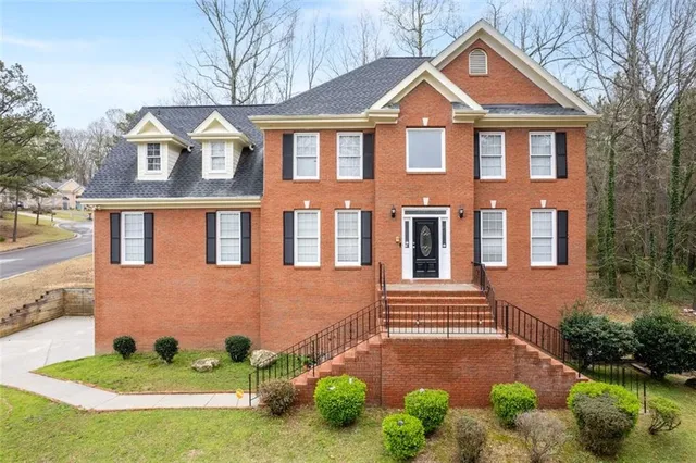 a front view of a house with garden