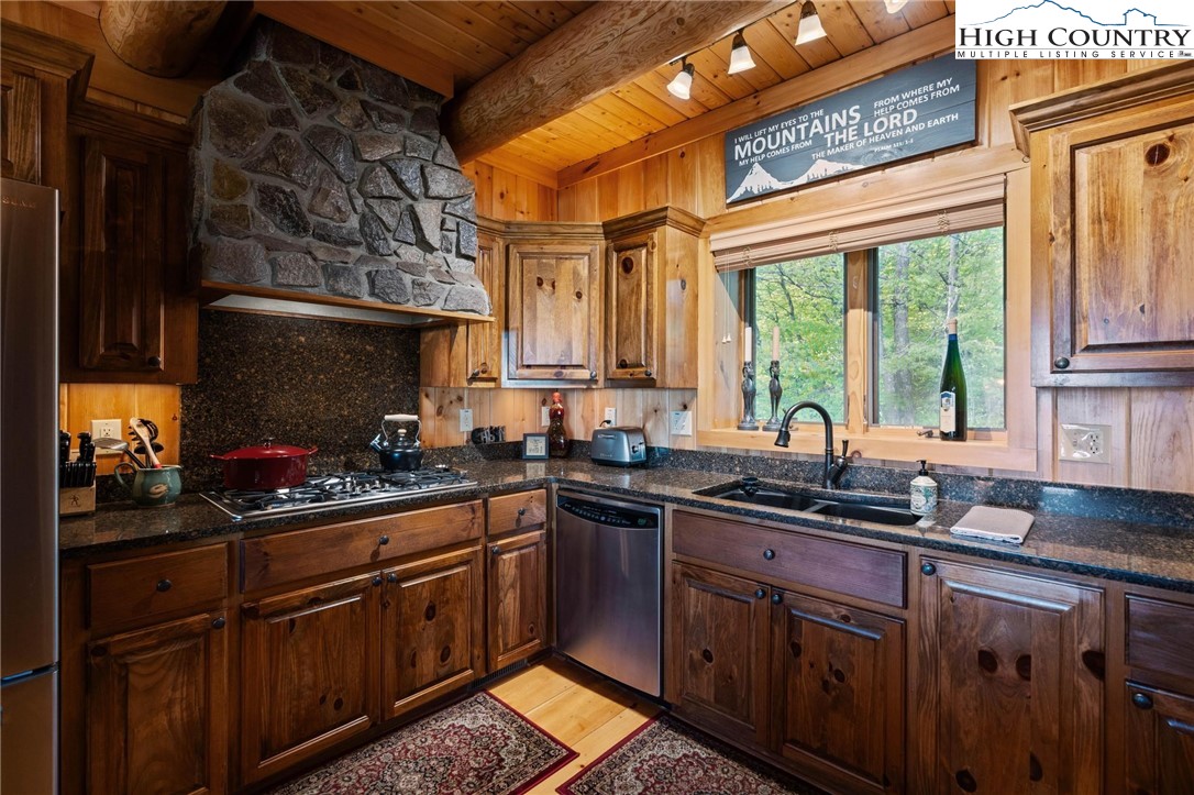 405 Elk Summit Drive Todd, NC 28684 - Photo 12 of 50 a kitchen with a sink stove and cabinets