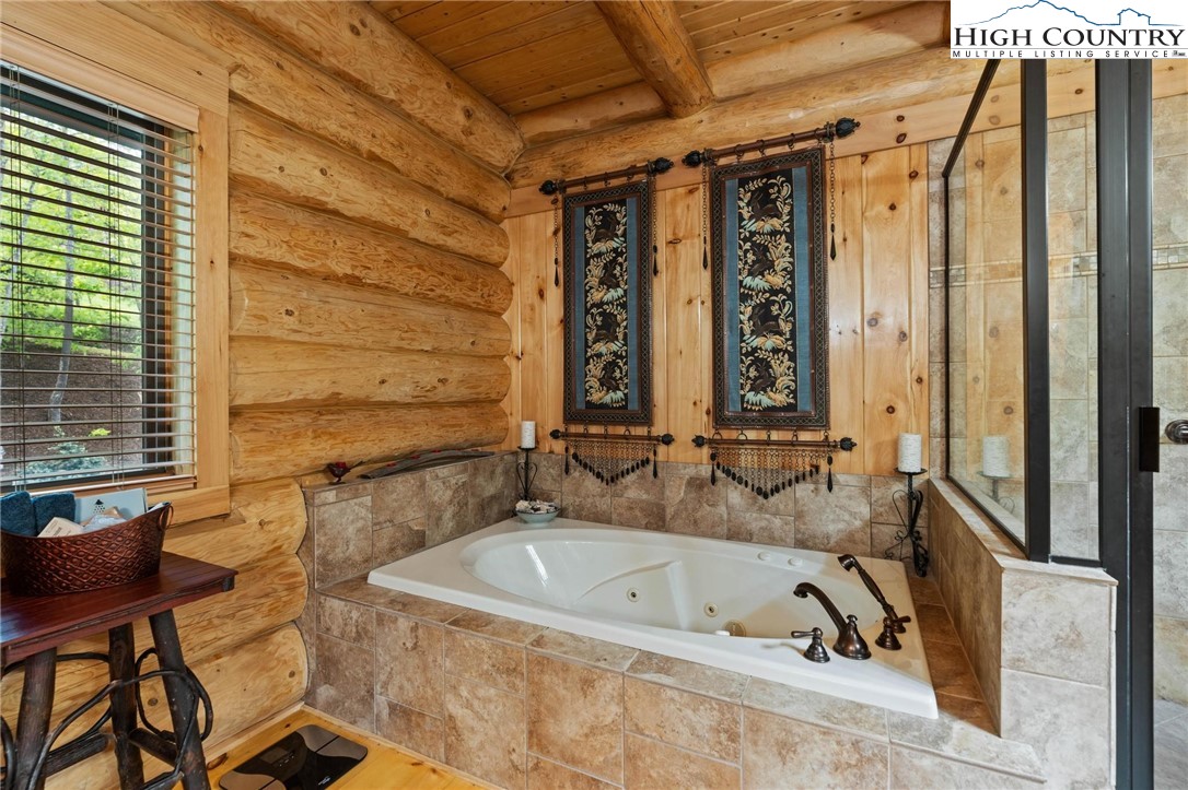 405 Elk Summit Drive Todd, NC 28684 - Photo 20 of 50 a bathroom with a granite countertop sink and a bathtub