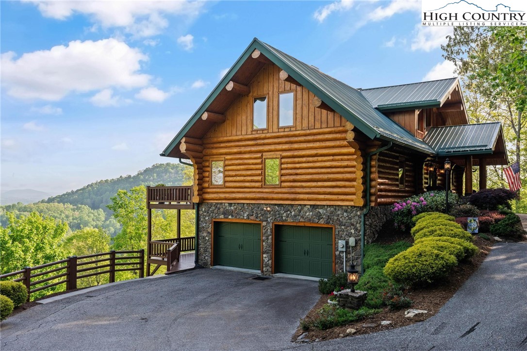 405 Elk Summit Drive Todd, NC 28684 - Photo 3 of 50 a front view of a house with garden