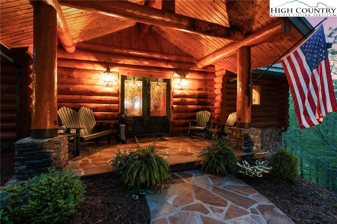 405 Elk Summit Drive Todd, NC 28684 - Photo 39 of 50 a view of a patio with table and chairs potted plants
