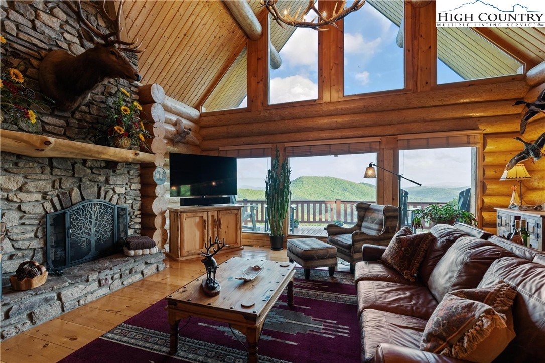 405 Elk Summit Drive Todd, NC 28684 - Photo 7 of 50 a outdoor living space with furniture and a fireplace