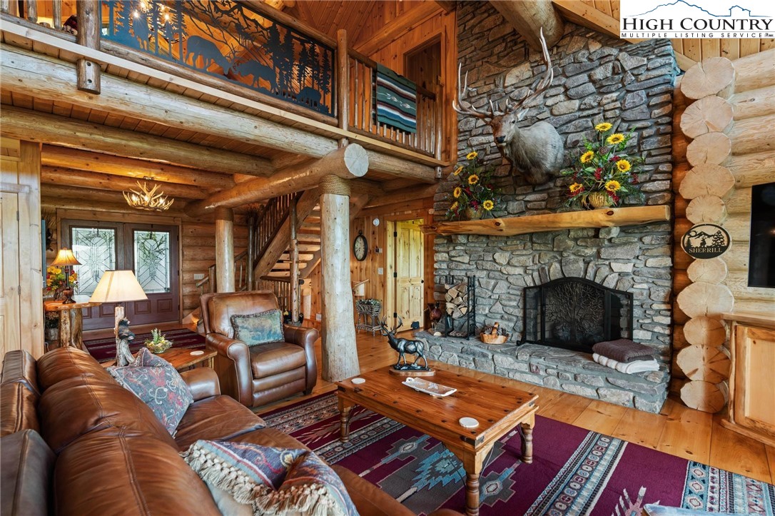 405 Elk Summit Drive Todd, NC 28684 - Photo 10 of 50 a living room with furniture and a fireplace