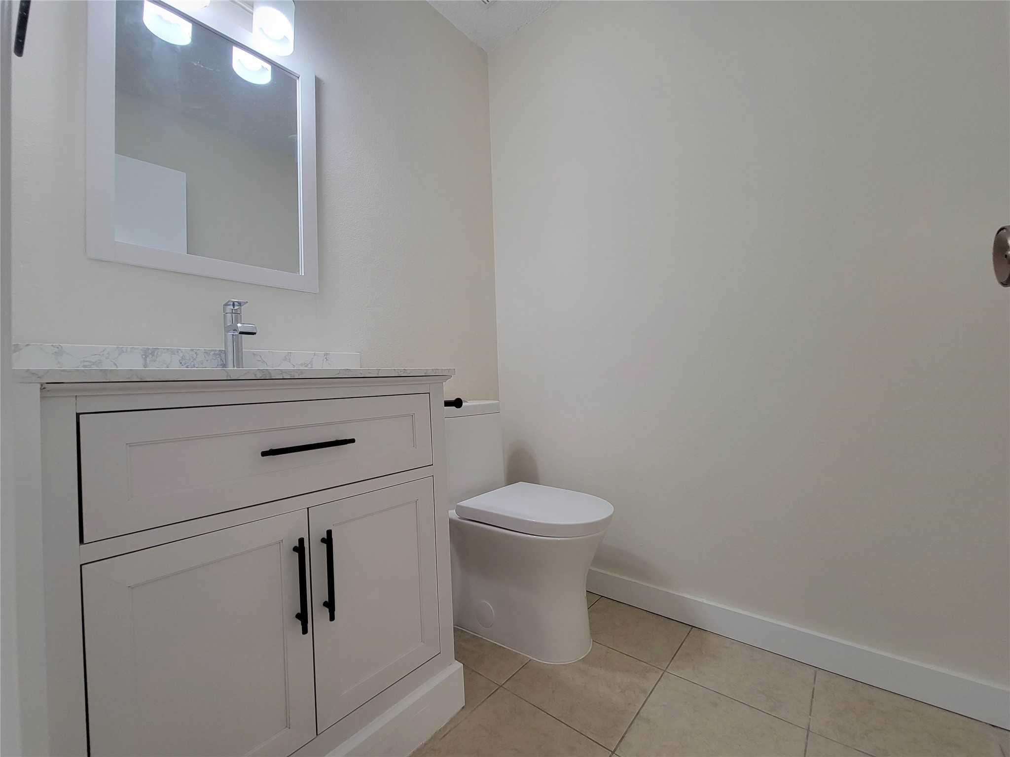 8706 Schick Road, Unit A Austin, TX 78729 - Photo 28 of 33 A well-appointed bathroom with a modern vanity and clean tile flooring.
