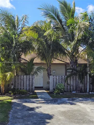 a view of a house with a yard and tree s