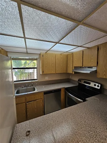 a kitchen that has a sink and a stove