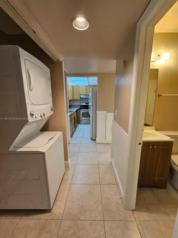 a utility room with cabinets dryer and washer