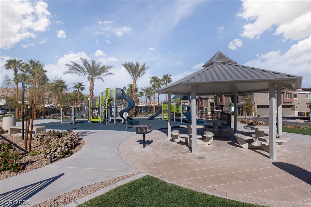 12232 Azure Gate Road, Unit 1 Las Vegas, NV 89183 - Photo 16 of 20 Shaded picnic pavilions stand adjacent to a modern playground area under clear desert skies.