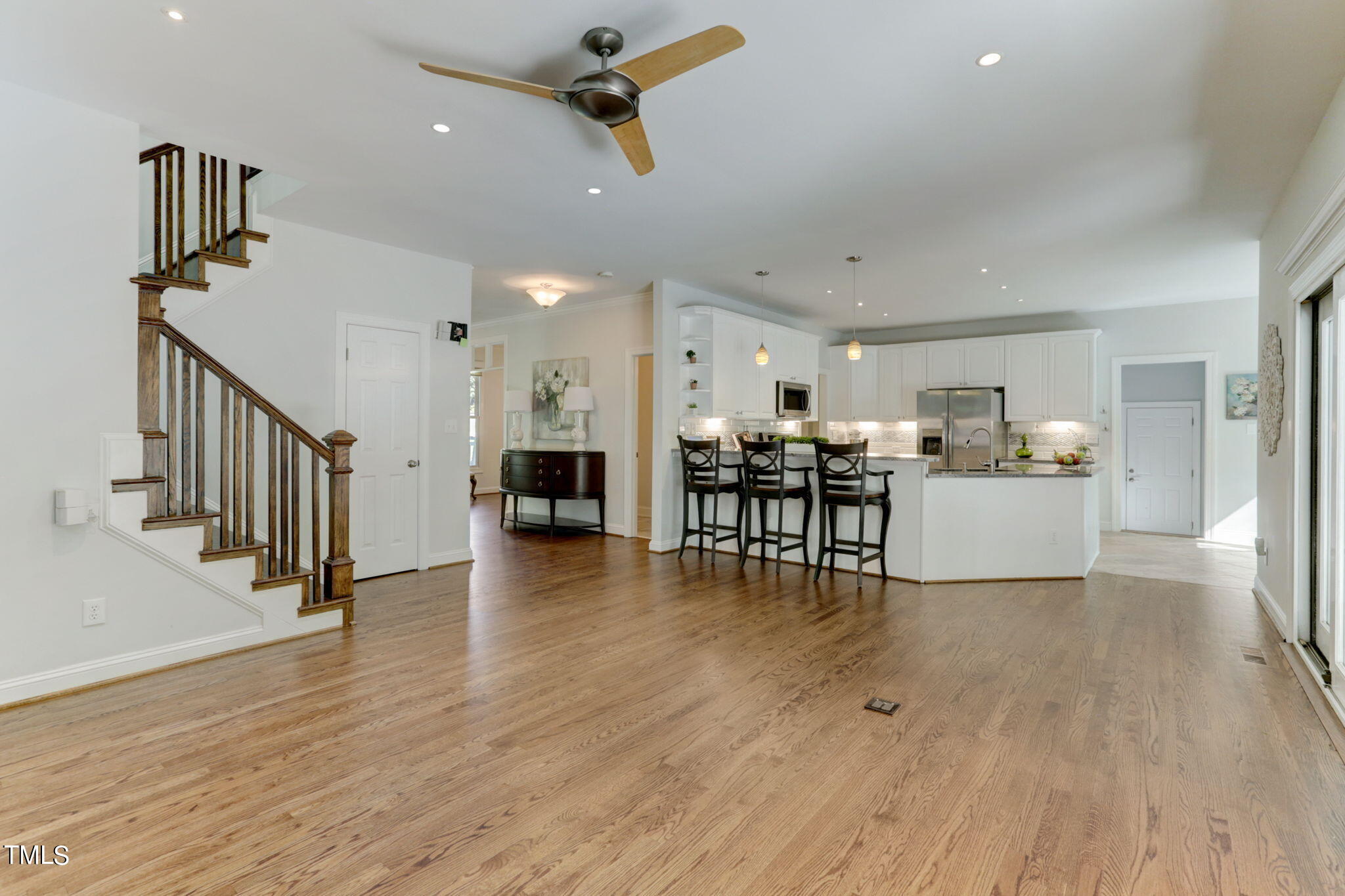 1029 Sunset Meadows Drive Apex, NC 27523 - Photo 21 of 52 a view of a livingroom with furniture wooden floor and ceiling fan