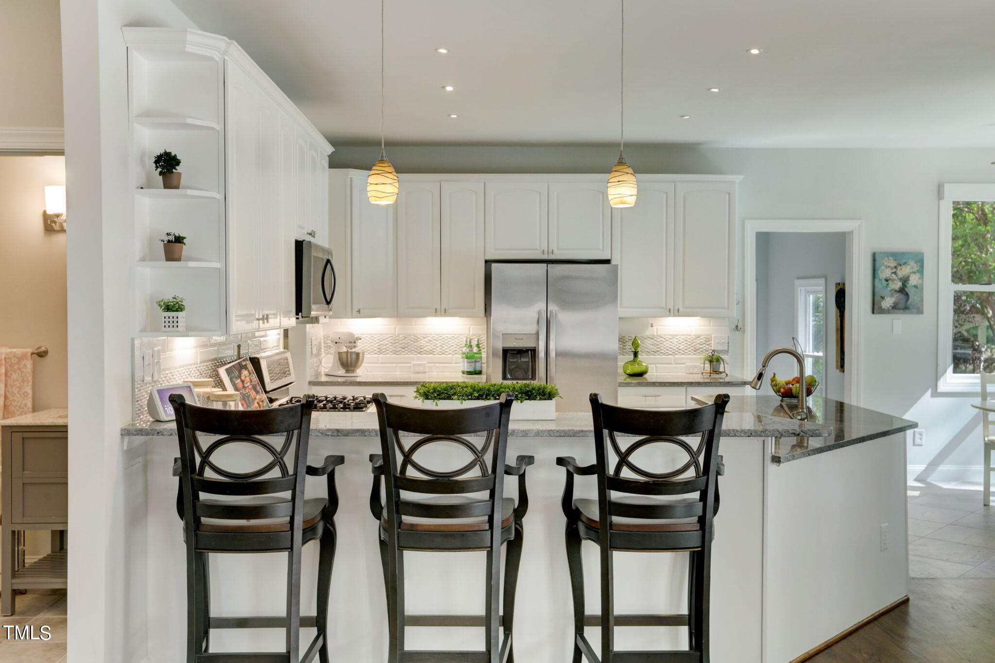 1029 Sunset Meadows Drive Apex, NC 27523 - Photo 22 of 52 a kitchen with a table chairs stove and cabinets