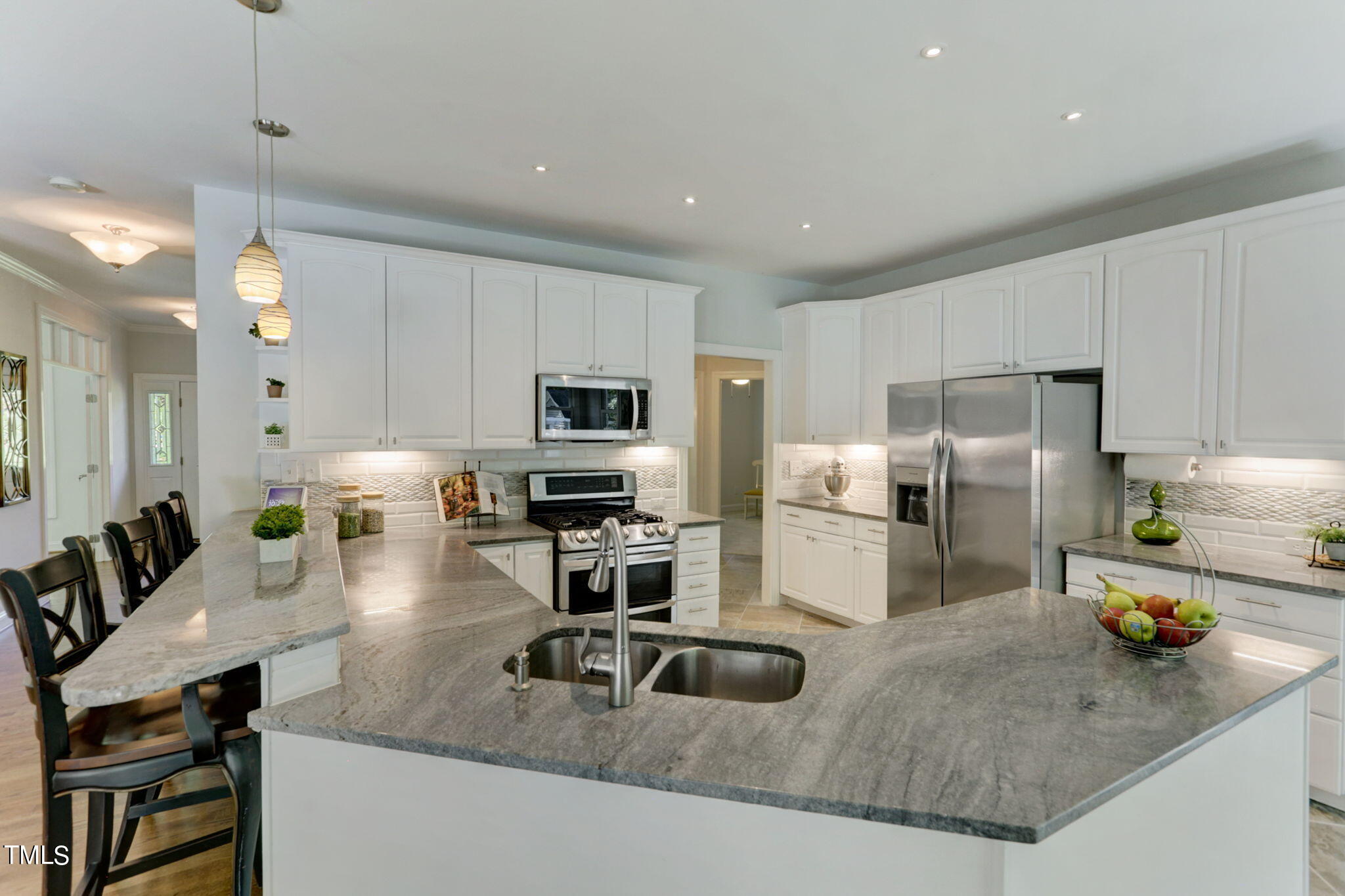 1029 Sunset Meadows Drive Apex, NC 27523 - Photo 23 of 52 a kitchen with stainless steel appliances granite countertop a sink a stove and a refrigerator