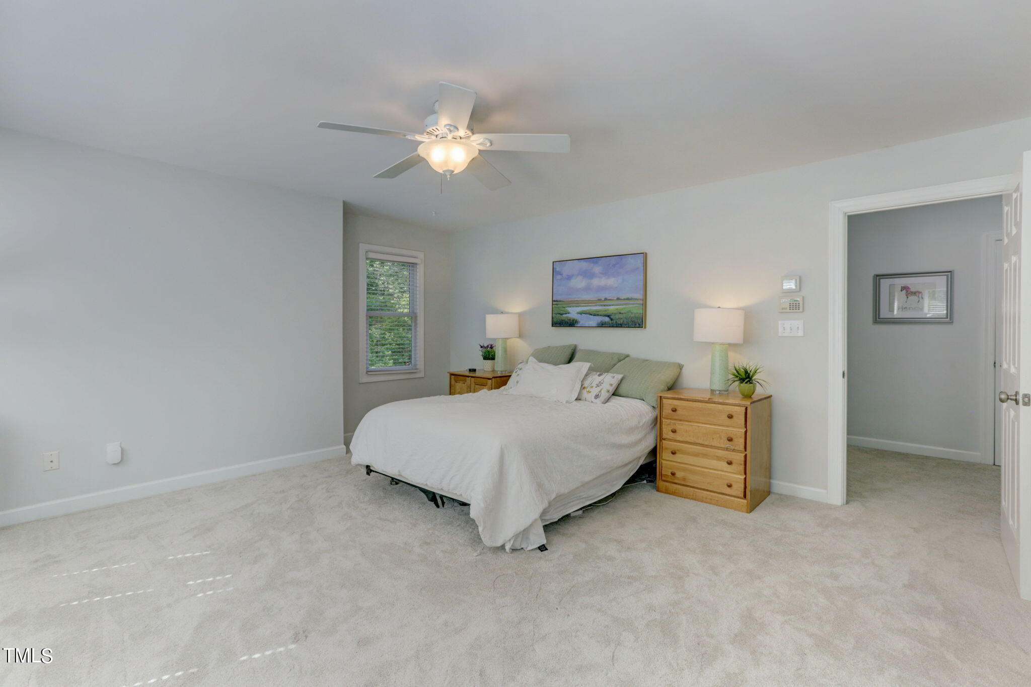1029 Sunset Meadows Drive Apex, NC 27523 - Photo 38 of 52 a spacious bedroom with a bed and a chandelier