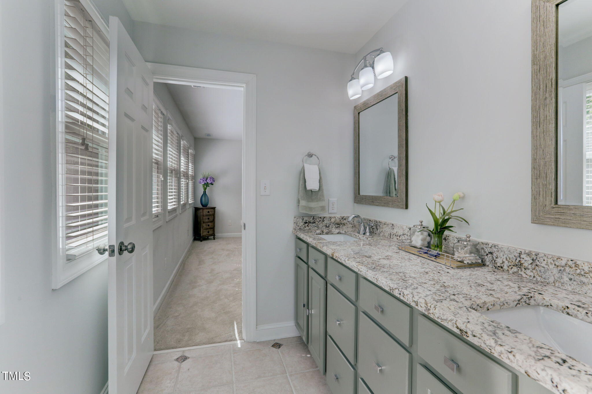 1029 Sunset Meadows Drive Apex, NC 27523 - Photo 42 of 52 a bathroom with a granite countertop sink and a mirror