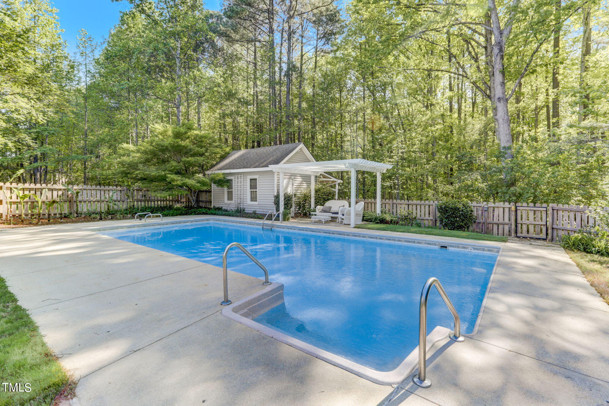 1029 Sunset Meadows Drive Apex, NC 27523 - Photo 7 of 52 a view of a patio with table and chairs with wooden floor and fence