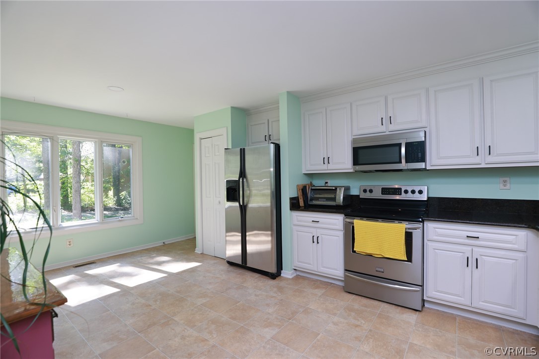 14210 Spring Gate Terrace Midlothian, VA 23112 - Photo 19 of 50 a kitchen with stainless steel appliances granite countertop a stove a sink and a refrigerator