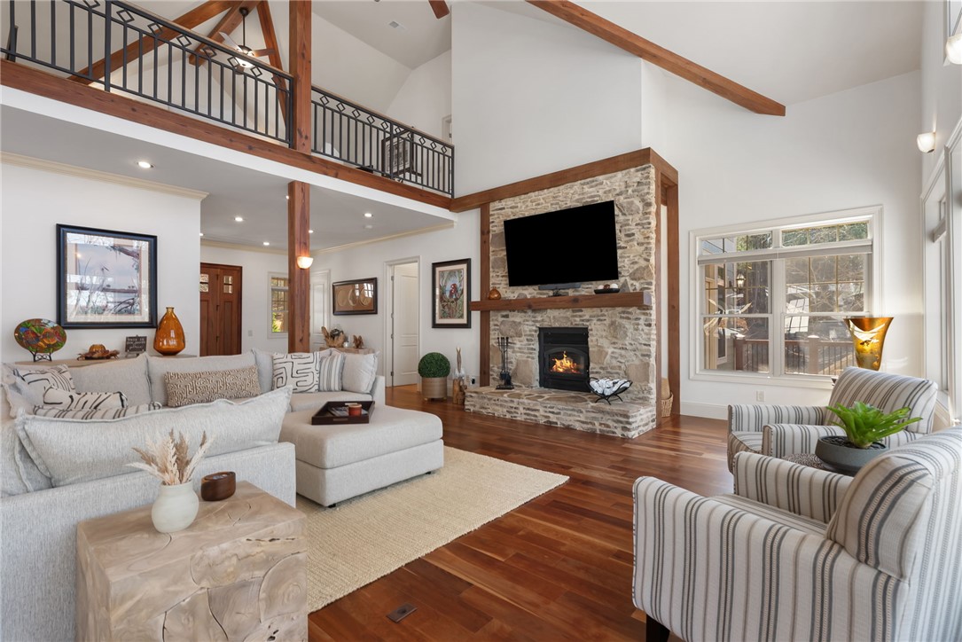 505 Northview Court Fair Play, SC 29643 - Photo 19 of 48 This airy living space features rich hardwood flooring and a prominent stone fireplace, perfect for gatherings.